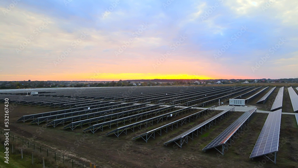 Aerial drone view into large solar panels at a solar farm at summer sunset. Solar cell power plants. footage HDR video 4k. Aerial drone view into large solar panels at a solar farm at summer sunset. Solar cell power plants. footage HDR video 4k.
