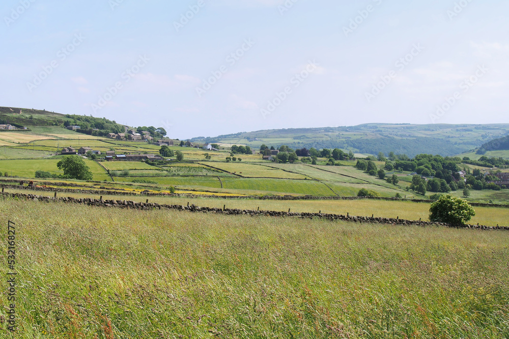 view of the calder valley in west yorkshire with village houses visible in the distance