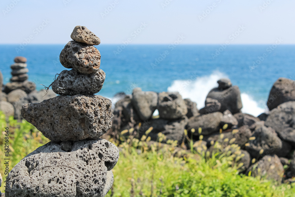 Stone tower on the beach. basalt