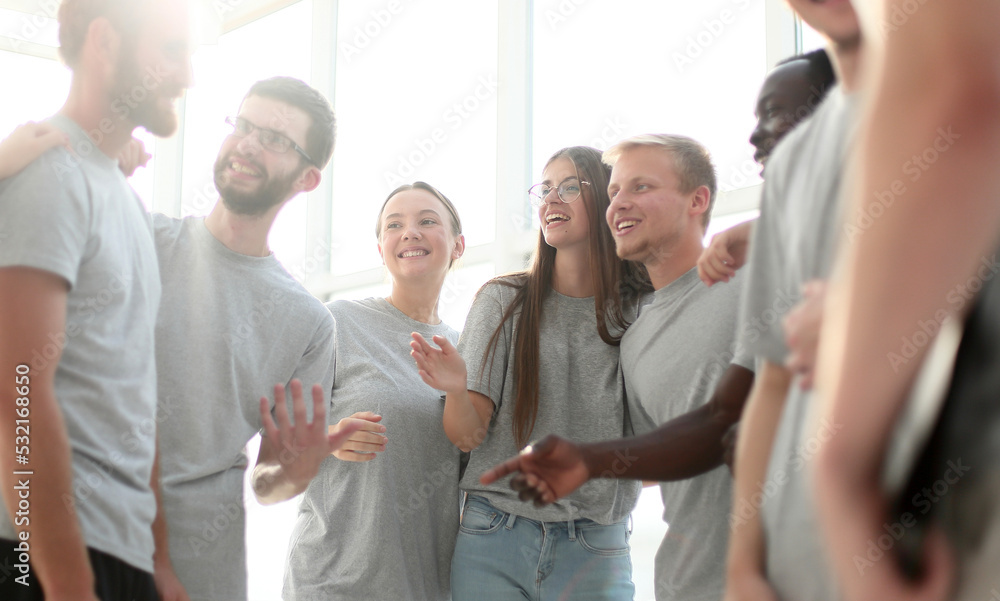 group of diverse young men in grey t-shirts standing together group of diverse young men in grey t-shirts standing together
