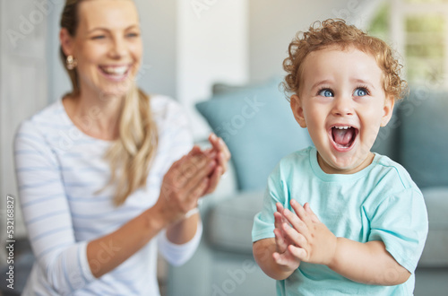 Happy, clapping hands and mother and son playing in the living room of their family home. Happiness, love and energy of parent and toddler having fun and cheering together in the lounge of a house.