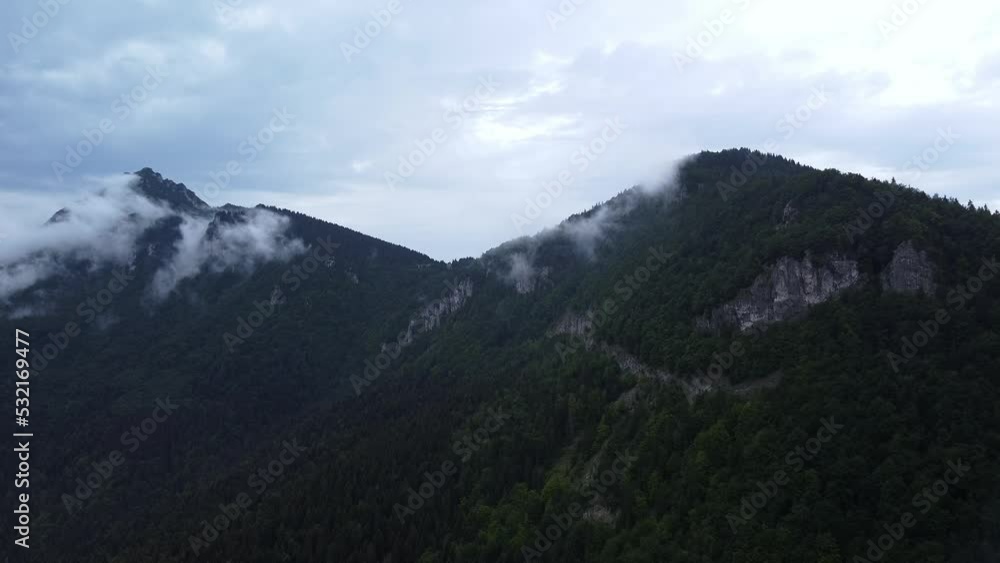 Misty mountain wood from bird-eye Aerial view. Lush clouds cover wild foggy mountain Misty mountain wood from bird-eye Aerial view. Lush clouds cover wild foggy mountain