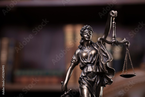 Law and justice concept. Justice symbol - Themis sculpture on gray background.