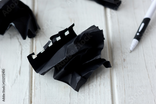 crumpled piece of black pap...