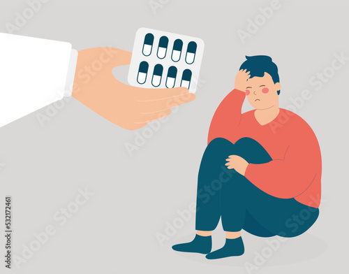 A hand gives meds and sedatives to a man to get rid of negative thoughts. Mental health and psychological problems. Addicted boy needs support because of depression. Drug addiction treatment concept.
