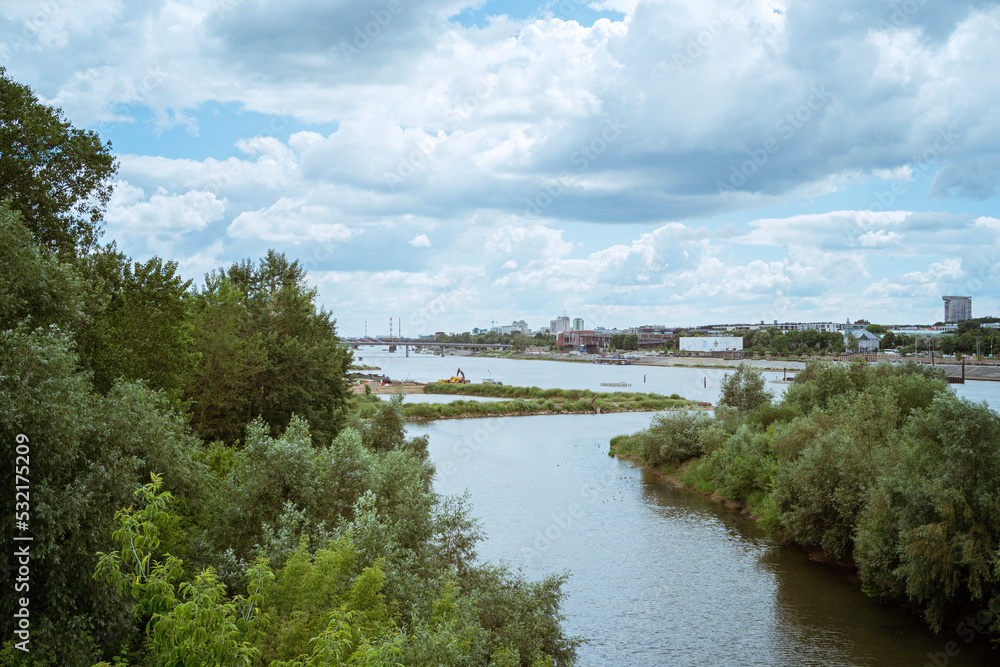 WARSAW, POLAND - JUNE 17, 2022, cloudy big city day in summer, Poland tall buildings skyscrapers and nature on the horizon over the surface of the Vistula river. city ​​panorama beautiful cityscape