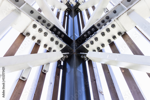 Part of a massive metal structure with bolts and rivets at the steel framework