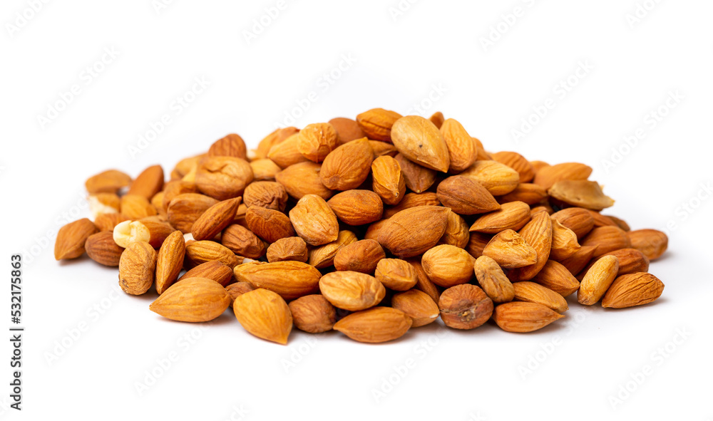 Apricot kernels peeled close-up as a background. Apricot grains heap isolated on white background. Apricot kernels peeled close-up as a background. Apricot grains heap isolated on white background.