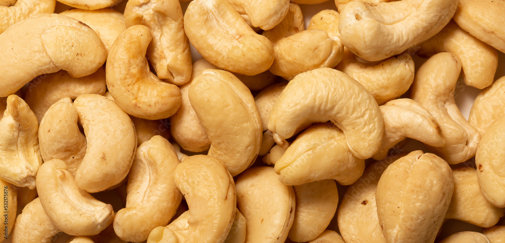 Cashew nuts as a background, top view. Cashew isolated on white background. Healthy foods. Cashew nuts as a background, top view. Cashew isolated on white background. Healthy foods.