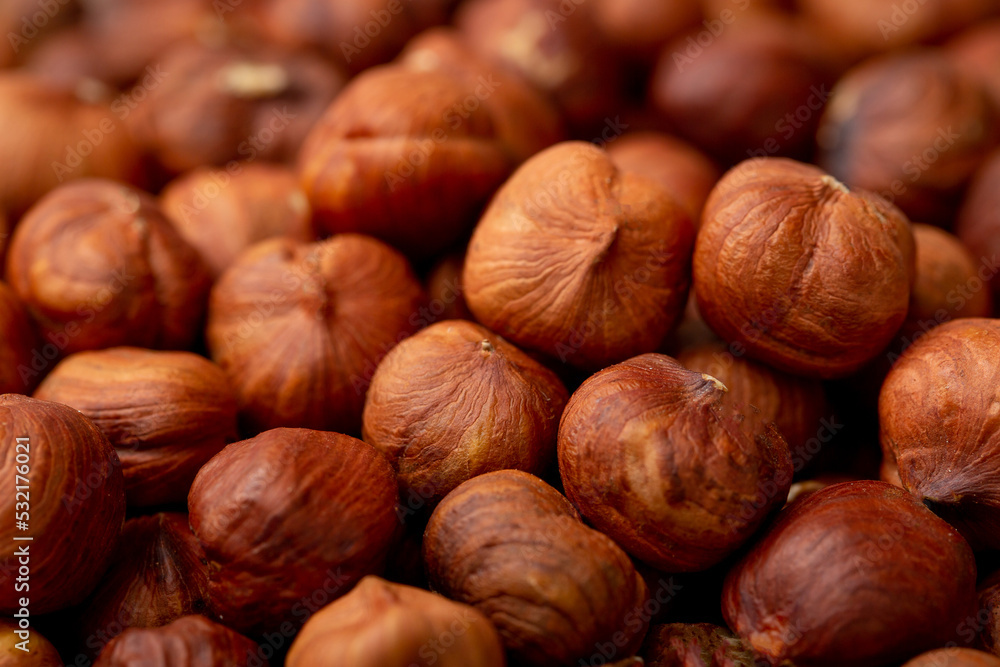 Heap of hazelnuts close-up. Peeled nuts. Hazelnut isolated on white background.