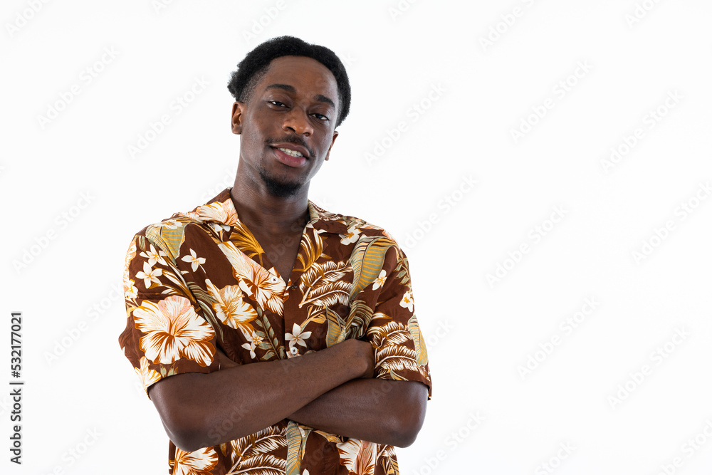 Serious handsome man looking at camera crossed arms in chest wearing casual printed shirt with flowers standing isolated on white background in studio. Serious handsome man looking at camera crossed arms in chest wearing casual printed shirt with flowers standing isolated on white background in studio.