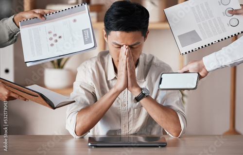 Stress, burnout and tired businessman overworked, overwhelmed and frustrated by his manager in an office. Headache, chaos and stressed out asian worker in trouble, struggle and mental health problems photo