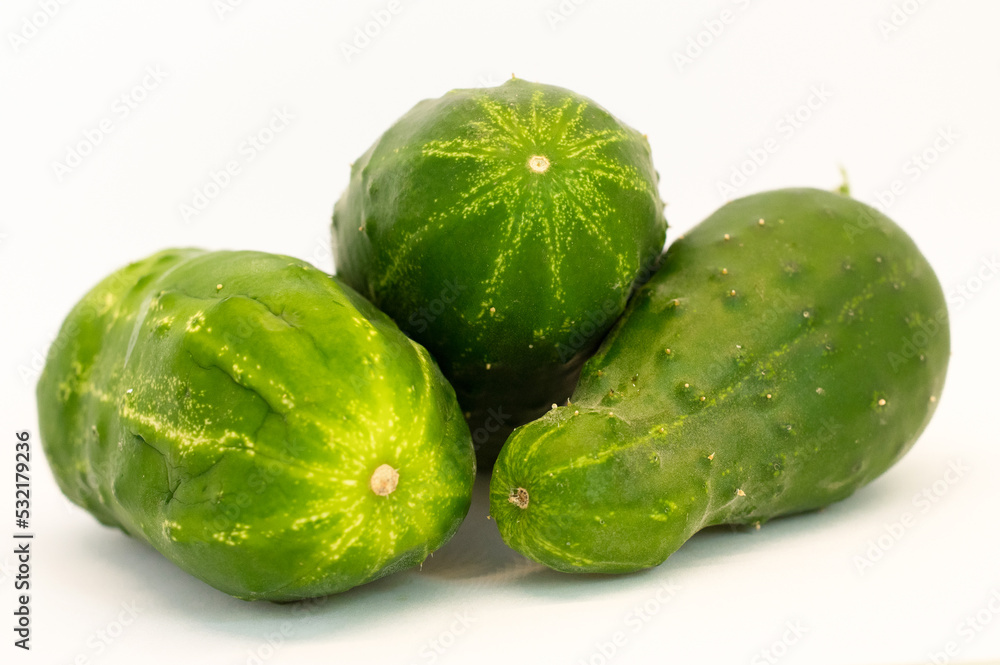 three organic cucumbers on white background three organic cucumbers on white background