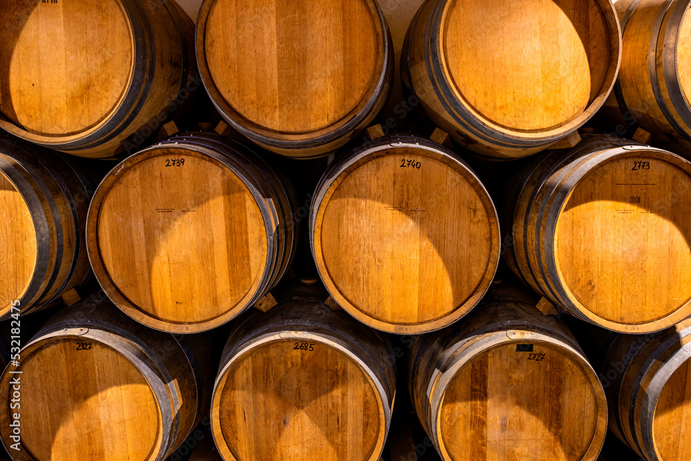 Stacked wine barrels. Wooden barrels containing macerating wine.