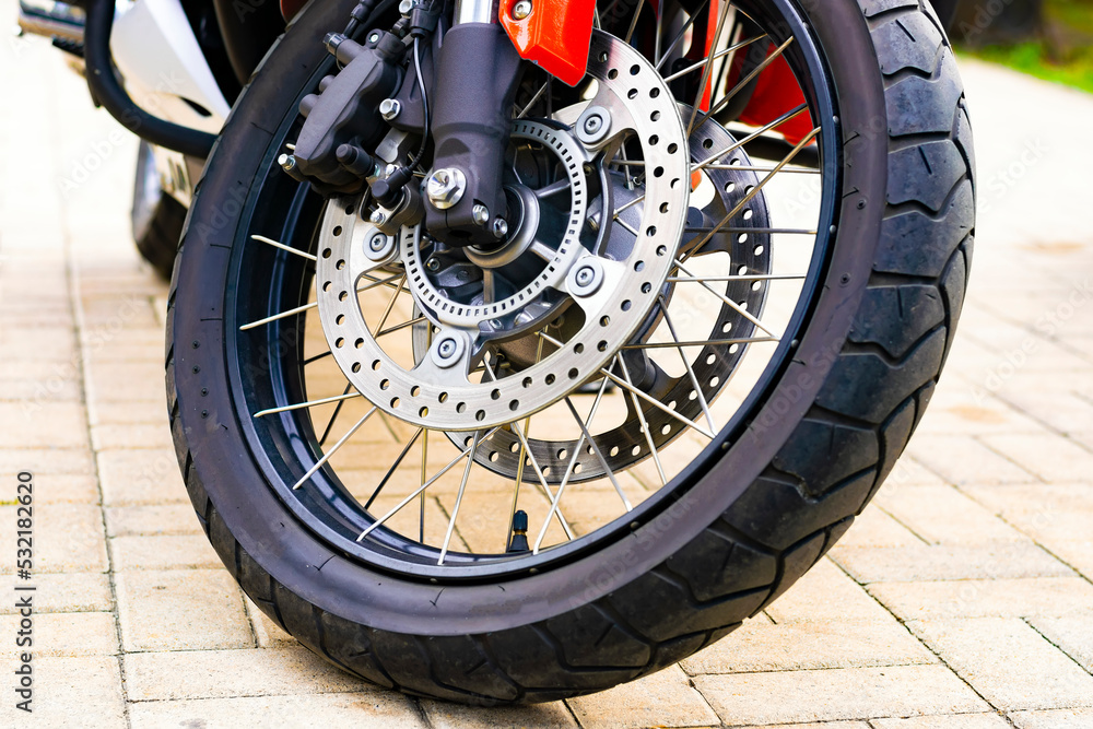 the front wheel of a sports motorcycle. brake system close-up the front wheel of a sports motorcycle. brake system close-up