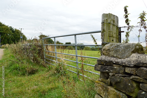 Metal Farm Gate on Country Lane on Stone Wall