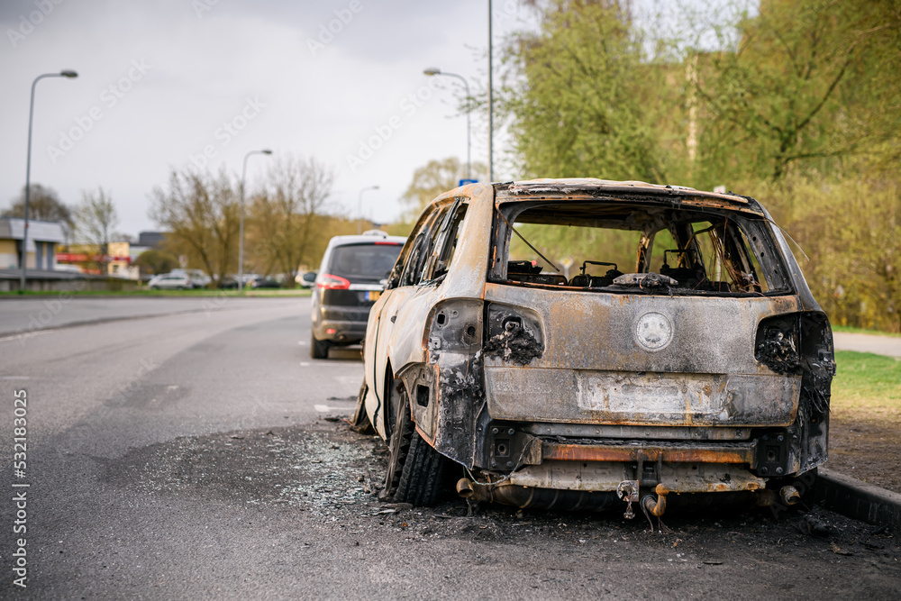 Wreck of burned car on the side of the road Wreck of burned car on the side of the road