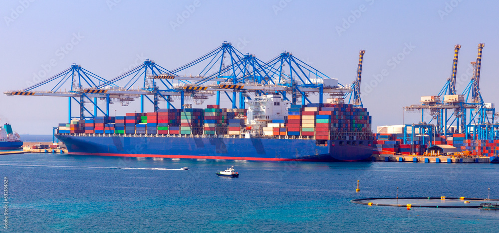A large container ship is loaded in the cargo port of Malta.