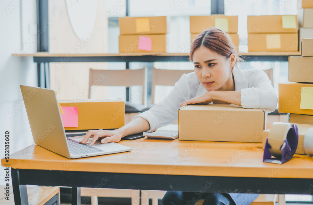 Online small business owners are sad and bored waiting for orders that haven't yet arrived. Online Retailers - Online Shopping Online small business owners are sad and bored waiting for orders that haven't yet arrived. Online Retailers - Online Shopping