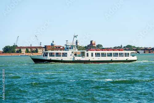 Empty white ferry or vaporetto in motion in the Venetian Lagoon on a sunny spring day. Venice, UNESCO world heritage site, Veneto, Italy, southern Europe.