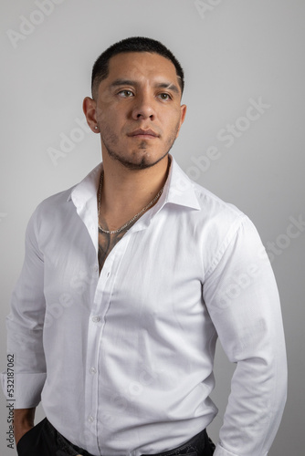 young latin man with short hair wear a white shirt, formal fashion in studio, beauty and lifestyle © Alejandro
