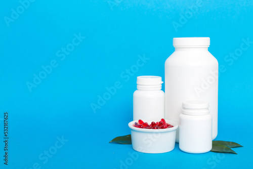 different drugs and health supplement pills with medicine bottle health care and medical top view. Vitamin tablets. Bottle with colored pills on table background. Multivitamins