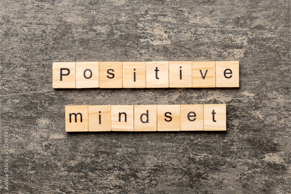 Fototapeta premium positive mindset word written on wood block. positive mindset text on cement table for your desing, concept