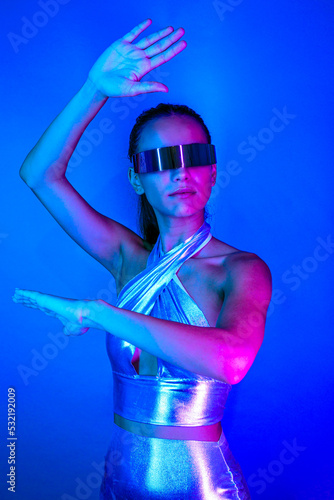 Self assure futuristic woman exploring cyberspace in VR goggles