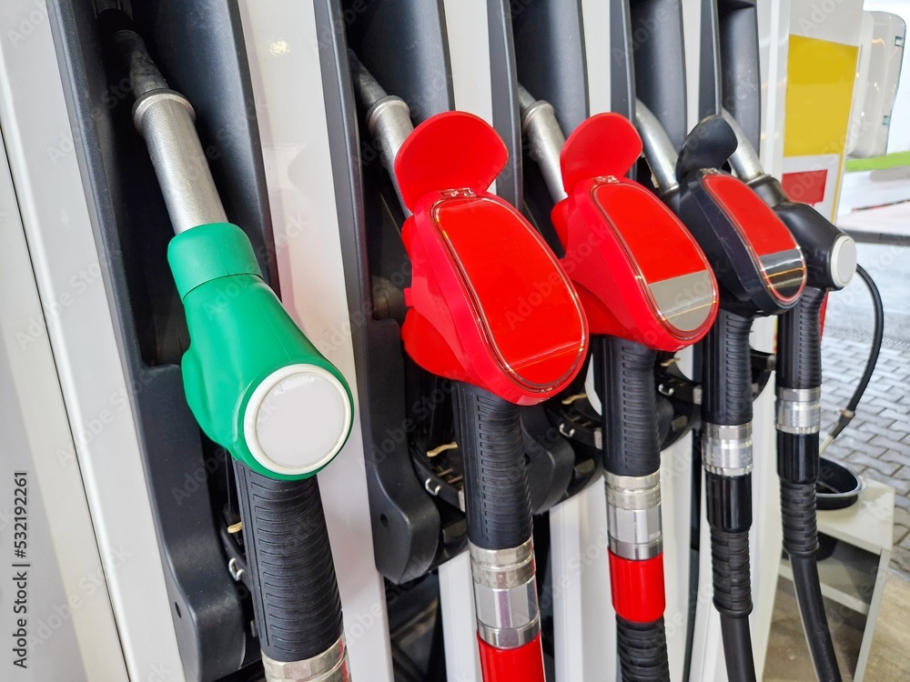 Closeup of a refueling stand with refueling guns at gas station Closeup of a refueling stand with refueling guns at gas station