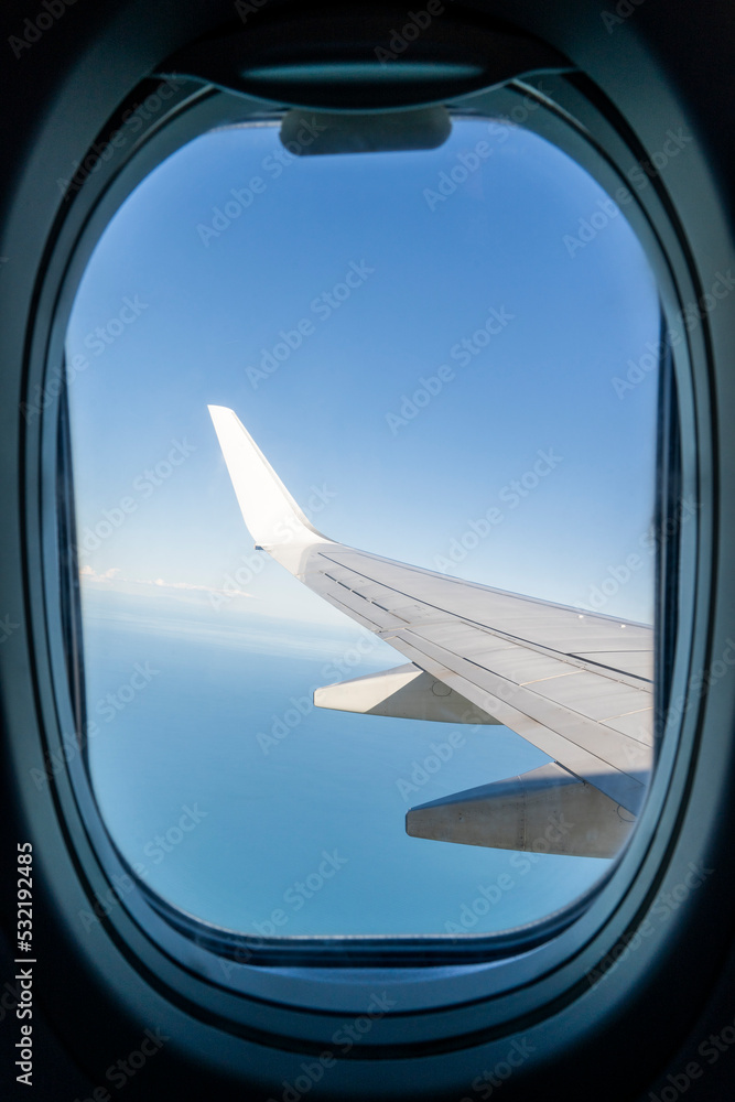 View from the inside or interior of the airplane. Airplane porthole window view from the passenger seat View from the inside or interior of the airplane. Airplane porthole window view from the passenger seat