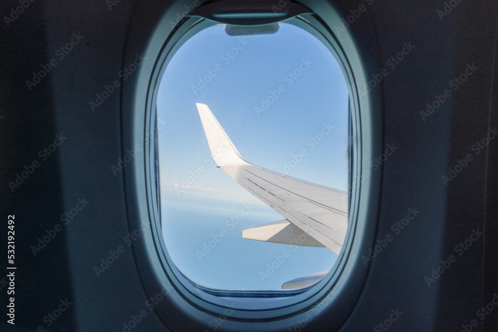 View from the inside or interior of the airplane. flying and travel. Airplane window view from the passenger seat View from the inside or interior of the airplane. flying and travel. Airplane window view from the passenger seat