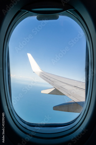 View from the inside or interior of the airplane. Airplane porthole window view from the passenger seat