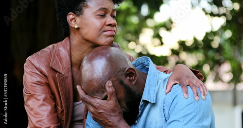 Upset man, woman consoling partner