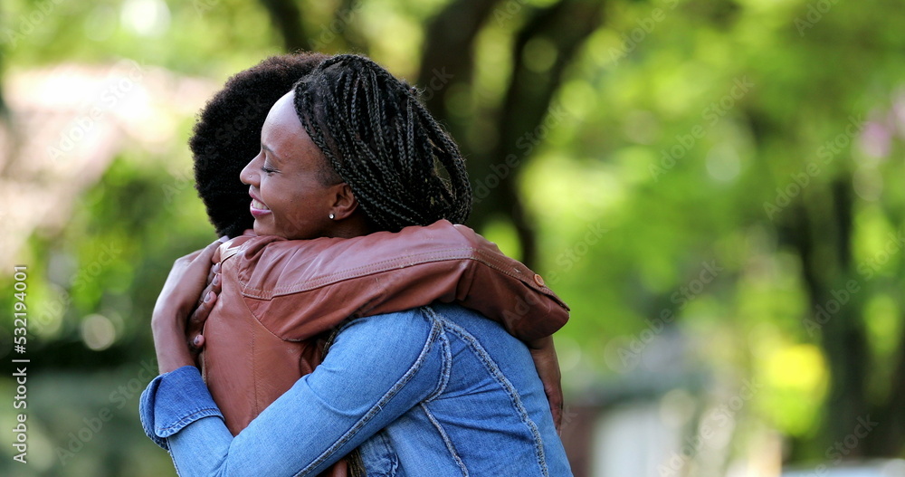 Two best friends meeting, African women hugging and embrace outside in street Two best friends meeting, African women hugging and embrace outside in street