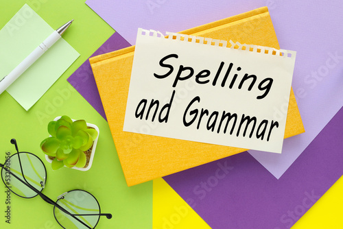 SPELLING GRAMMAR. text on paper on yellow and green background photo