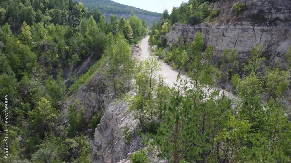 Aerial view of old abandoned limestone quarry among forested hills. Aerial view of old abandoned limestone quarry among forested hills.