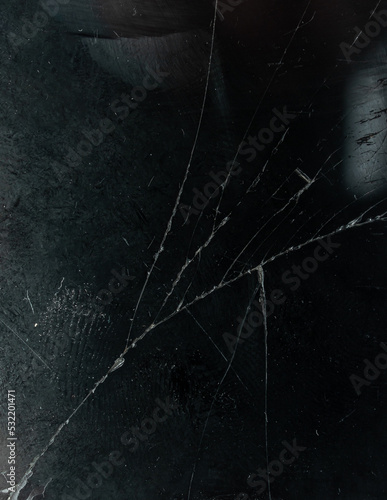 detail macro photo of dirty smartphone display device surface with smudgy fingerprints, dust, scratches and broken glass.