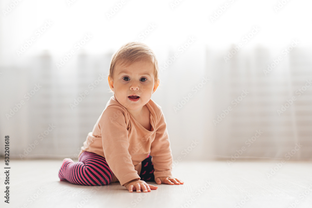 Baby girl crawls on the floor white Baby girl crawls on the floor white