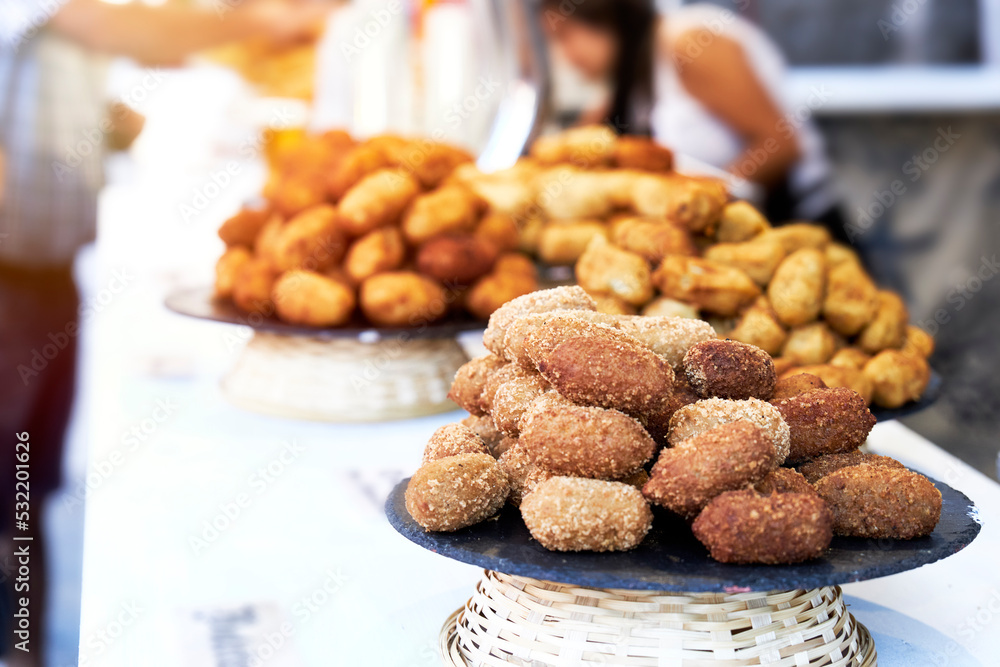 Fototapeta premium Bar counter with plates of croquettes and pasties and blur effect