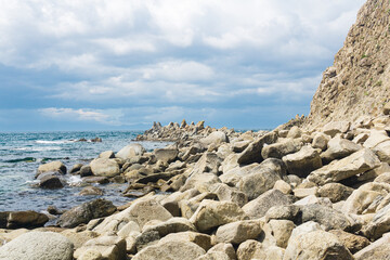 Papier peint photo  sharp jagged basalt rocks on the sea coast  © Evgeny