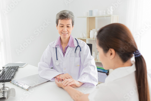 asian doctor use hand screening pulse rate and vital sign of patient  doctor treatment patient in hospital  adult health check up   they talking about disease symptom
