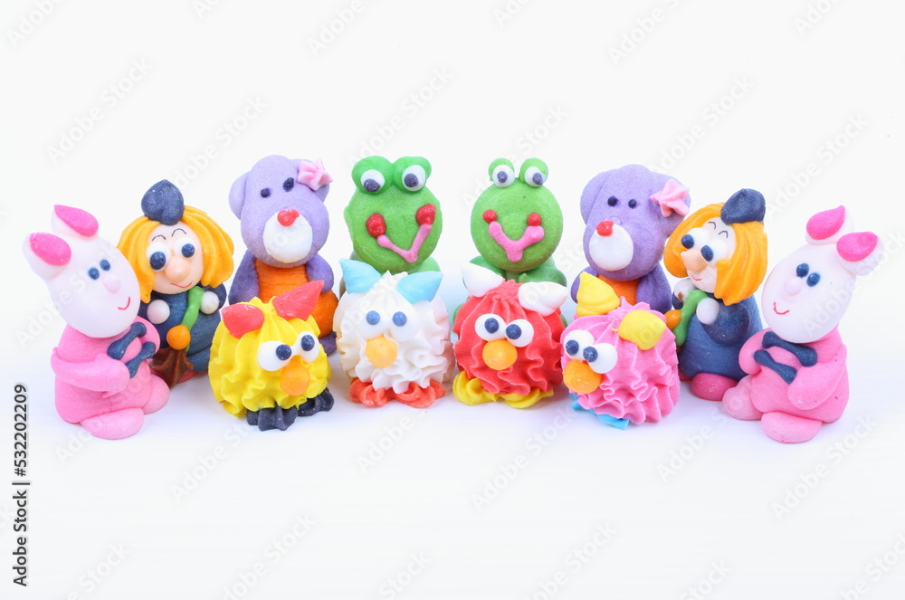 Doll made of colored sugar isolated on white Doll made of colored sugar isolated on white