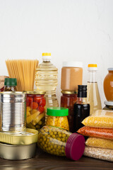 Emergency survival food set on dark wooden kitchen table