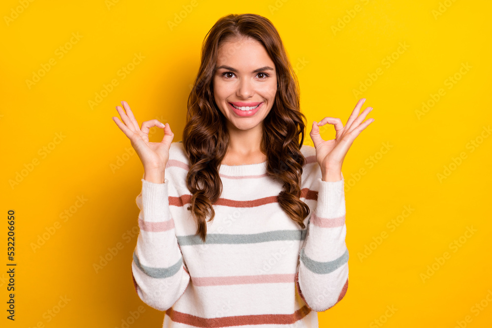 Photo of positive satisfied person toothy smile hands fingers demonstrate okey symbol isolated on yellow color background Photo of positive satisfied person toothy smile hands fingers demonstrate okey symbol isolated on yellow color background