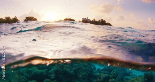 Split view of the tropical sea and island during sunset in the Maldives photo