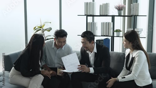 Asian customer with his wife happy sign contract success agreement home buing with real estate property agent realtor and marketing officer  photo