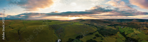 Panorama of welsh countryside. British landscape. Aerial panoramic view of typical british farmers fields and some sheep. England UK. Scenic British Countryside at Summer. 