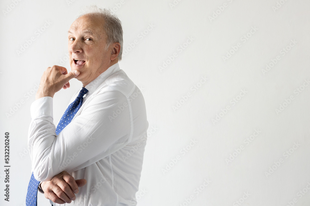 Portrait of pensive mature businessman touching chin. Senior manager wearing shirt and tie standing with open mouth and looking at camera. Mature businessman concept Portrait of pensive mature businessman touching chin. Senior manager wearing shirt and tie standing with open mouth and looking at camera. Mature businessman concept