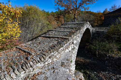 View of the traditional stone Agiou MIna Bridge in Epirus, Greece in Autumn. photo