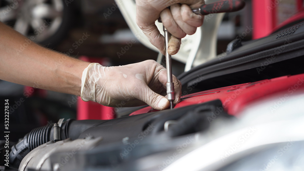 An auto mechanic is cleaning the engine compartment. car service. close-up. An auto mechanic is cleaning the engine compartment. car service. close-up.